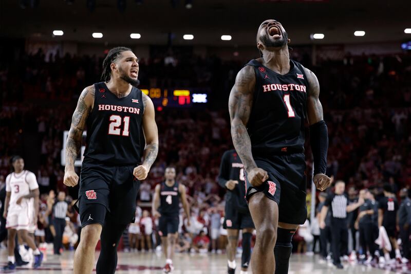 Houston guard Emanuel Sharp (21) and guard Jamal Shead (1) celebrate during the second half of the team's NCAA college basketball game against Oklahoma on Saturday, March 2, 2024, in Norman, Okla.