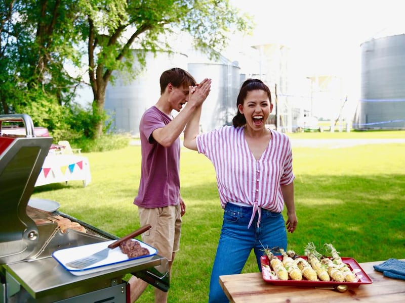 Molly Yeh gives her husband Nick a high-five as they prepare for a cookout with friends.