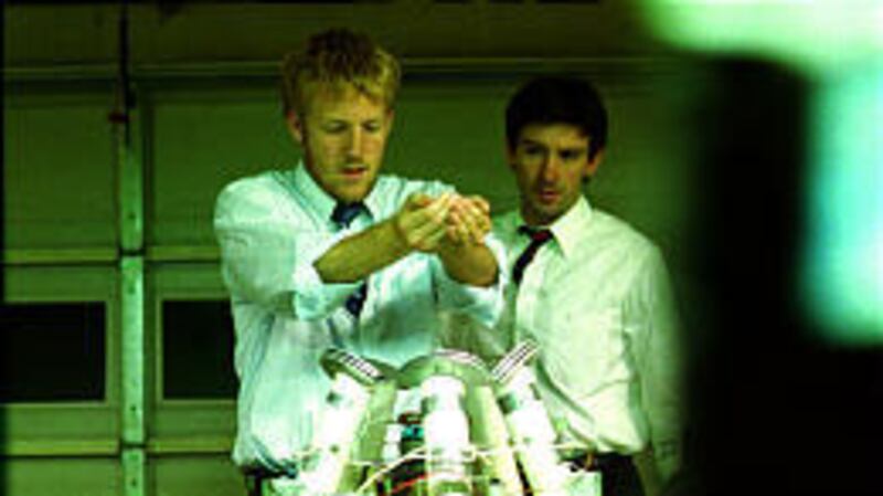 Abe (David Sullivan) and Aaron (Shane Carruth) tinker with their invention. The film's mostly nonprofessional cast is a bit acting-challenged.