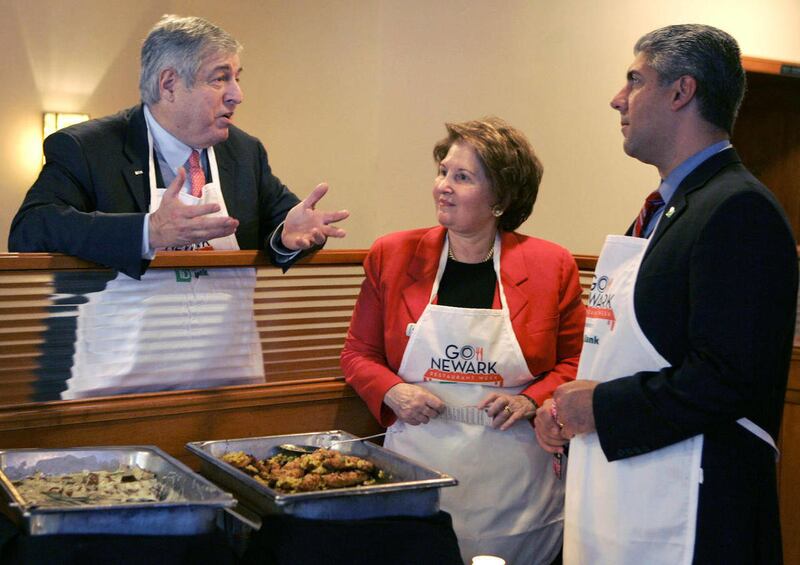 FILE - In this Nov. 3, 2008 file photo, Tim Zagat, left, and his wife, Nina Zagat, center, talk with Nicholas Mecili, an executive with TD Bank at 60 Park Place Grill, a bar and restaurant, in Newark, N.J. Google has bought the restaurant review service Z