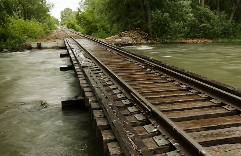 High water runs under a railroad track near the Rendezvous Park in Logan on Monday, June 12, 2017.