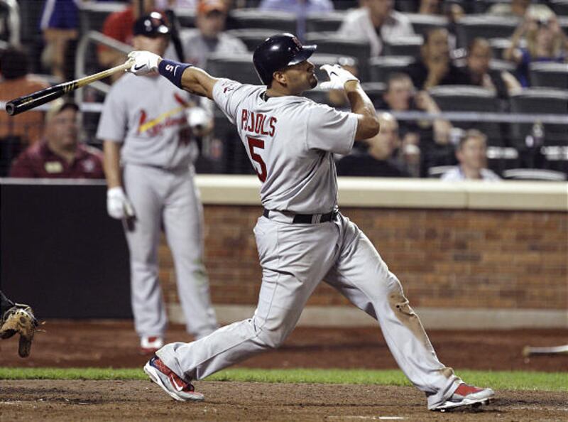 St. Louis' Albert Pujols follows through on a grand slam in the 10th inning Tuesday.