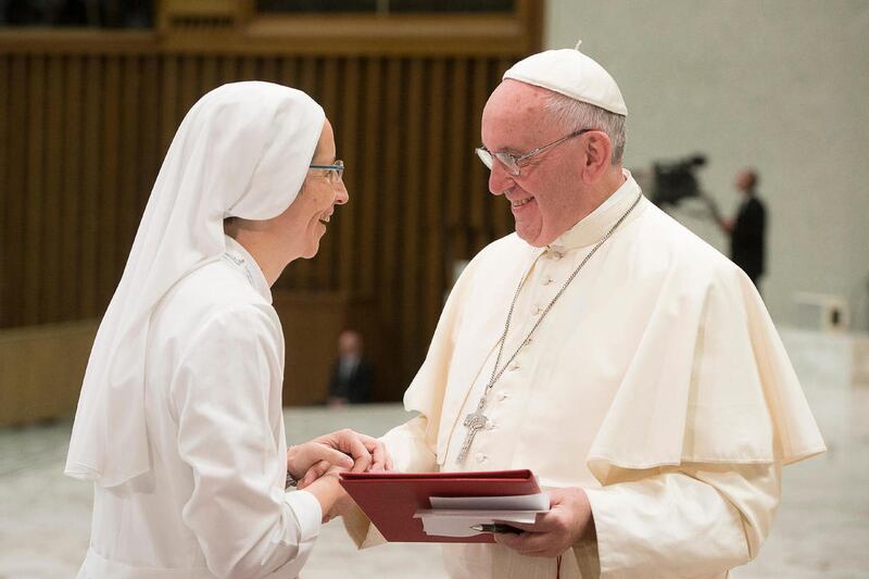 Pope Francis shares a word with Sister Sara, left, during a meeting with a group of young people who is participating in the International Congress for Young People in Consecrated Life, taking place in Rome this week, at the Vatican, Thursday, Sept. 17, 2