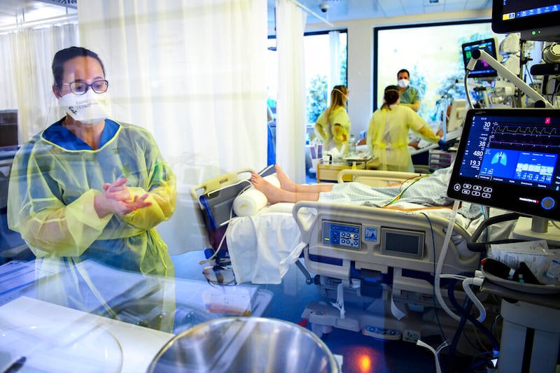 Medical workers treat a patient with COVID-19 at a hospital.