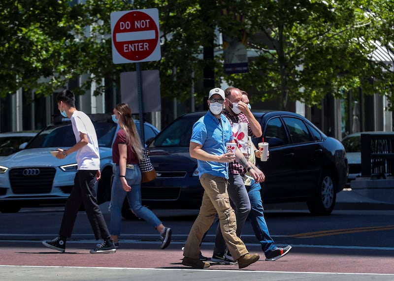 People wear masks as they walk on Main Street in Salt Lake City on Wednesday, June 24, 2020.