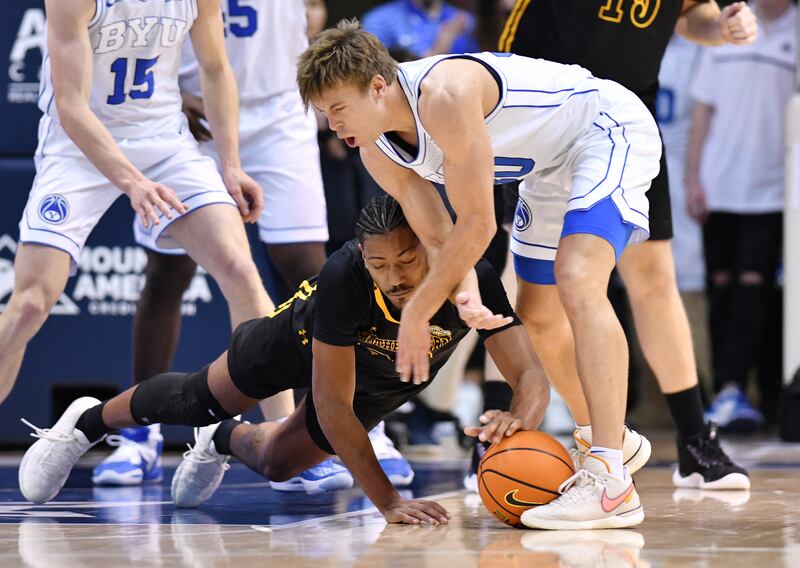 Southeastern Louisiana guard Alec Woodard and BYU guard Dallin Hall battle for the ball at the Marriott Center in Provo.