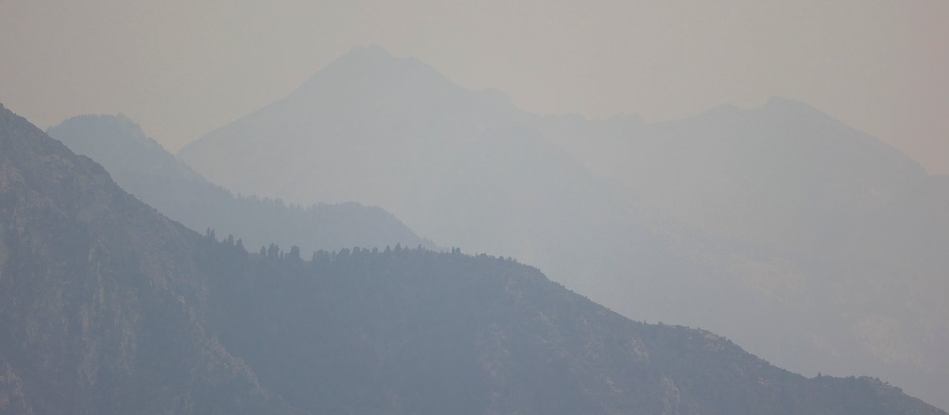 Smoky air hangs over the Wasatch Mountains on Tuesday, Aug. 10, 2021.