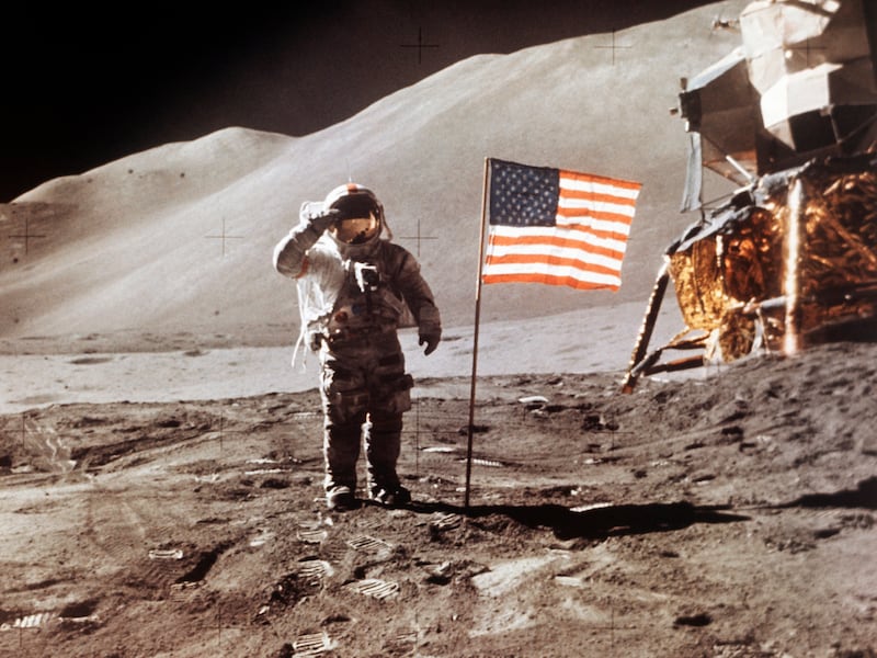 Apollo 15 Lunar Module Pilot James B. Irwin stands beside the fourth American flag planted on the moon.