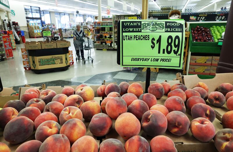 A shopper looks for produce at Reams Food Store in Sandy, Utah.