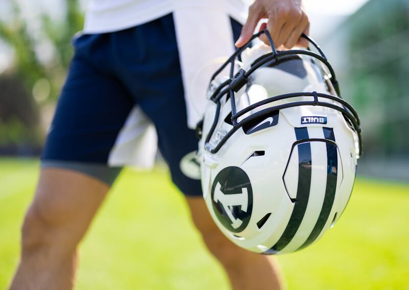 A Built Brands logo can be seen on the helmet of this BYU player during fall camp in 2021.