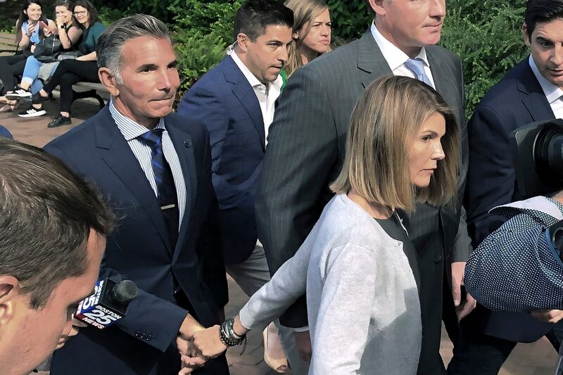 Lori Loughlin departs federal court in Boston with her husband, Mossimo Giannulli.
