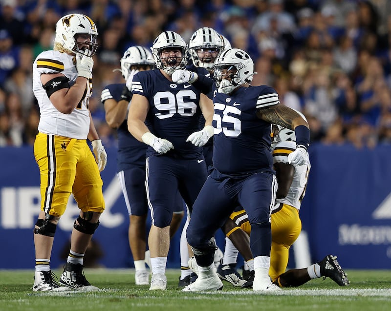 BYU defensive linemen Lorenzo Fauatea (55) and Bruce Mitchell celebrate a big play during game at LaVell Edwards Stadium.