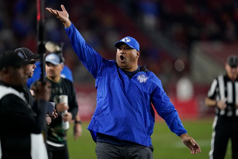 BYU coach Kalani Sitake exhorts the fans during game against Southern California in Los Angeles, Saturday, Nov. 27, 2021.