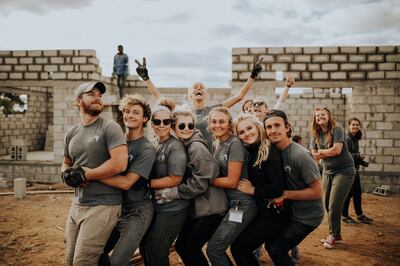 A group of volunteers with "Somewhere Devine" pose for a photo in front of the new Harper Anne Medical Clinic, which they helped build, in the remote village of Mwembeshi, Zambia. The clinic will serve 17 villages and over 30,000 people.