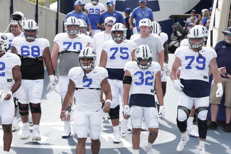 BYU players make their way to the field during fall camp in Provo.