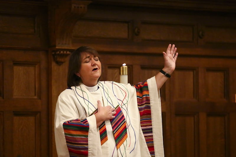 Bishop Karen Oliveto raises her hand during a song at First United Methodist Church in Salt Lake City on Sunday, Jan. 13, 2019. In February, leaders of the United Methodist Church will meet to decide how to approach ordination and marriage for LGBT member