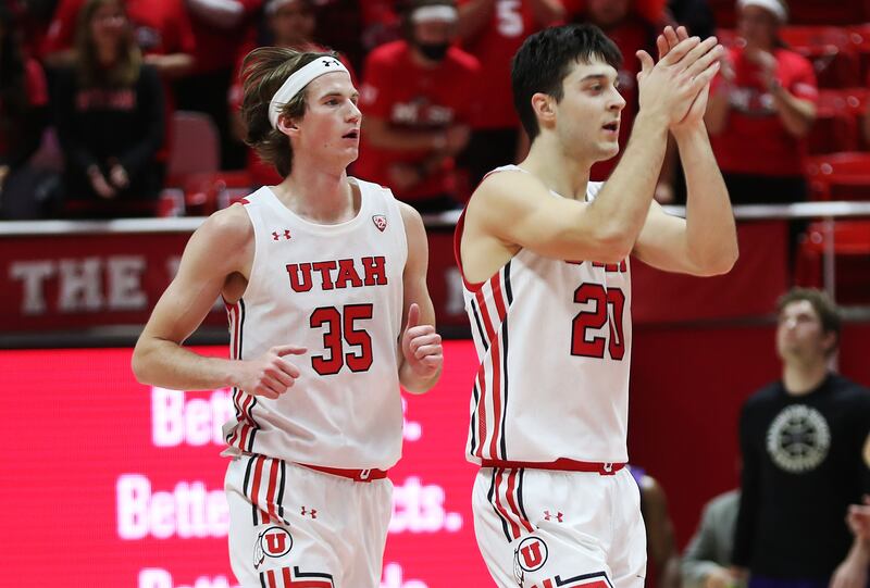 Utah guard Lazar Stefanovic (20) and Utah Utes center Branden Carlson come off the court after a basket in Salt Lake City.