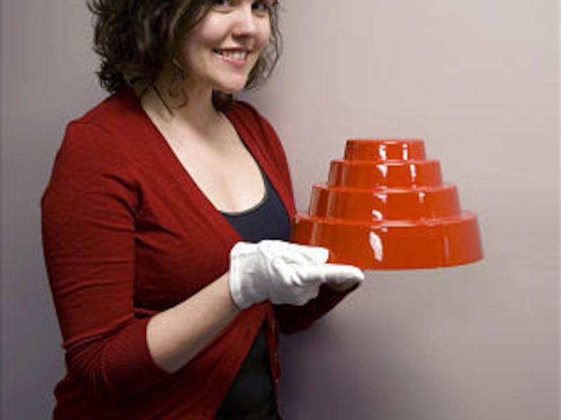 Elizabeth Higgins holds a hat like rock group Devo wore in the video for the hit "Whip It."