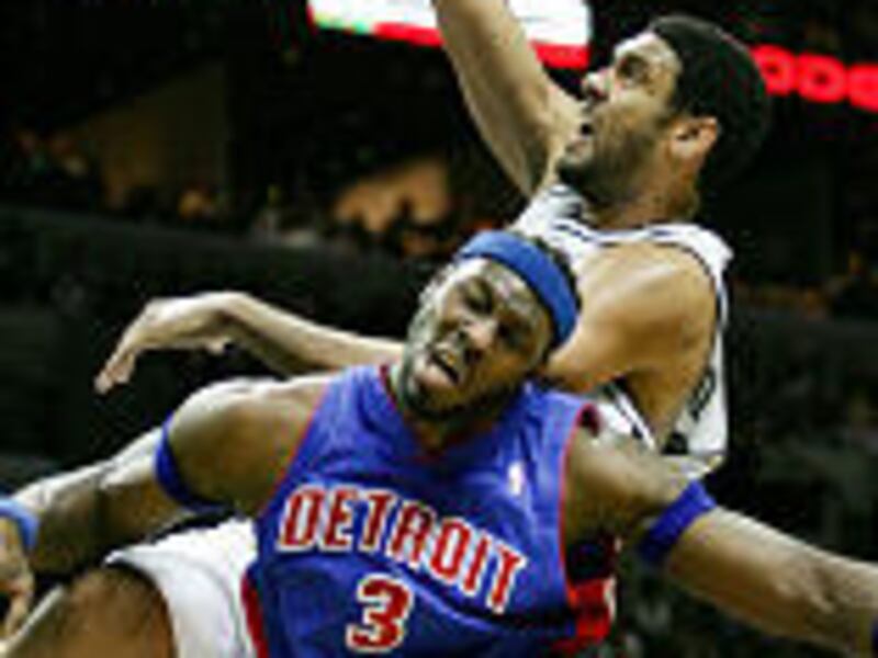 San Antonio's Tim Duncan slams home two points over Detroit Pistons' Ben Wallace.