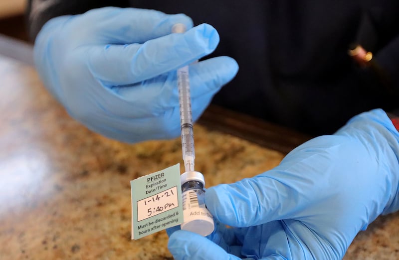 A pharmacist prepares a Pfizer-BioNTech COVID-19 vaccine at Summit Senior Living in Kearns on Thursday, Jan. 14, 2021.