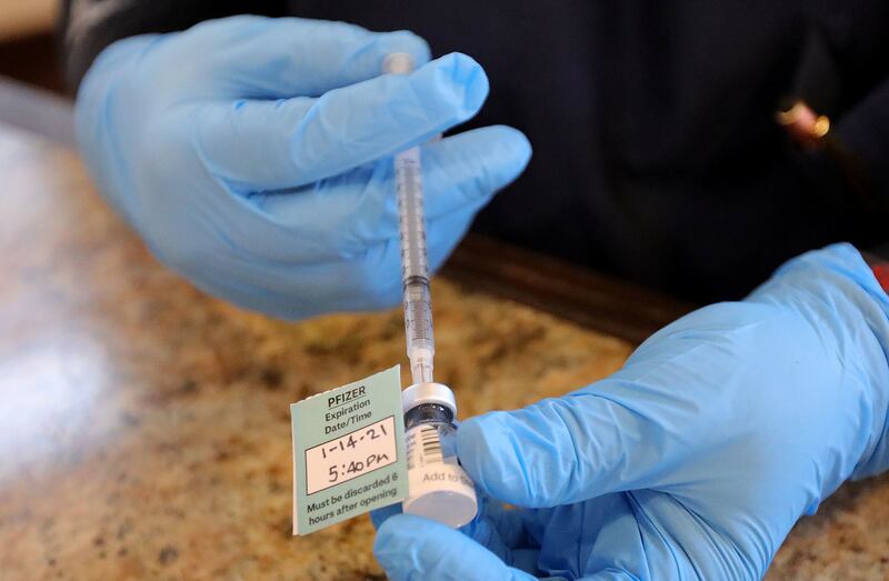A pharmacist prepares a Pfizer-BioNTech COVID-19 vaccine at Summit Senior Living in Kearns on Thursday, Jan. 14, 2021.