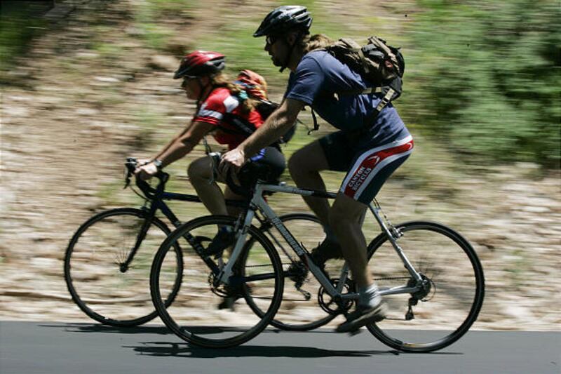 Jackie Concannon, left, and Eric Bunce bike their way up Emigration Canyon in Salt Lake City on July 5.
