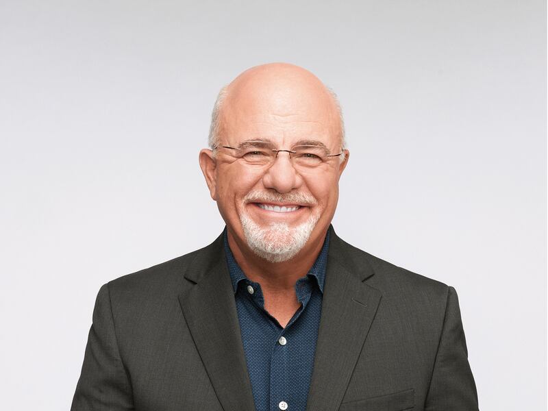 Dave Ramsey smiles against a white background in a black suit.