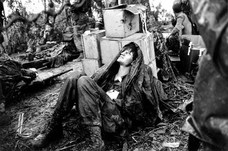 In this May 19, 1969, file photo, a wounded U.S. paratrooper grimaces as he awaits medical evacuation in South Vietnam during the Vietnam War.