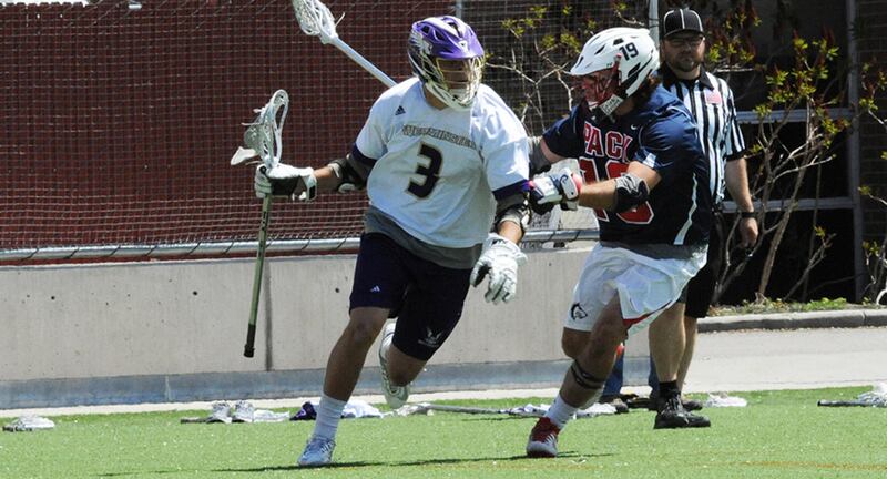 Thomas Sarjeant (left-center) carries the ball past a defender. Sarjeant and Westminster play Rockhurst in the semifinals of the RMAC Tournament on Friday.