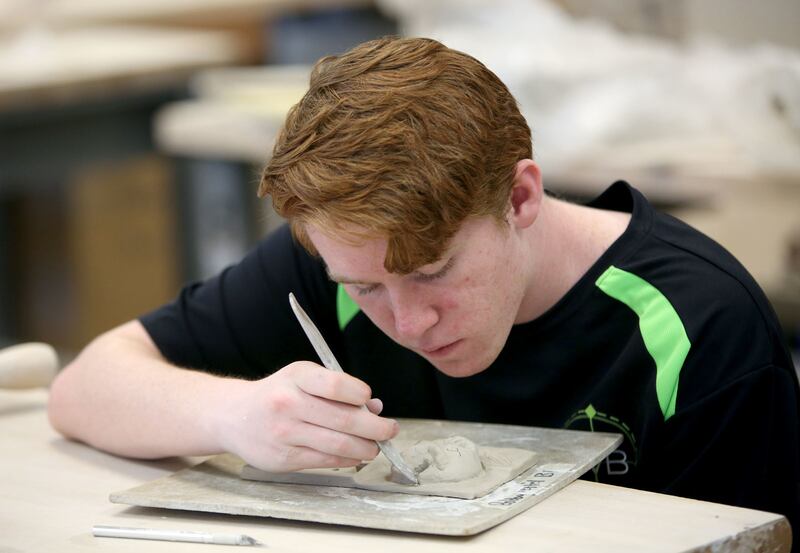 Bobby, who is learning to manage his stress and anxiety, works on a ceramics project at Murray High School in Murray on Thursday, May 17, 2018.
