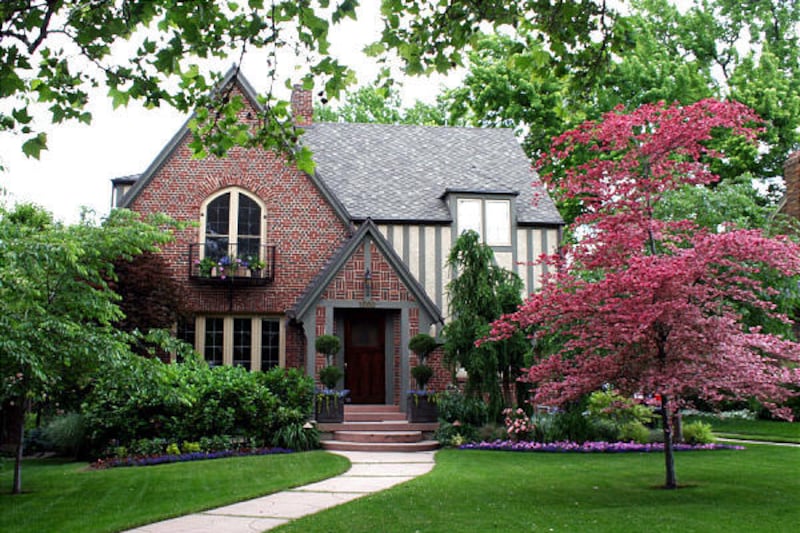 Tudor homes are characterized by steeply pitched roofs, decorative half-timbering, patterned brick work and multipaned windows.
