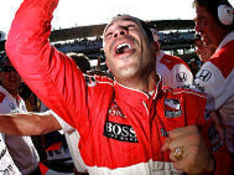 Helio Castroneves celebrates winning pole position for the Indianapolis 500.