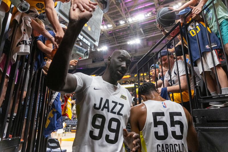 Tacko Fall high-fives fans.