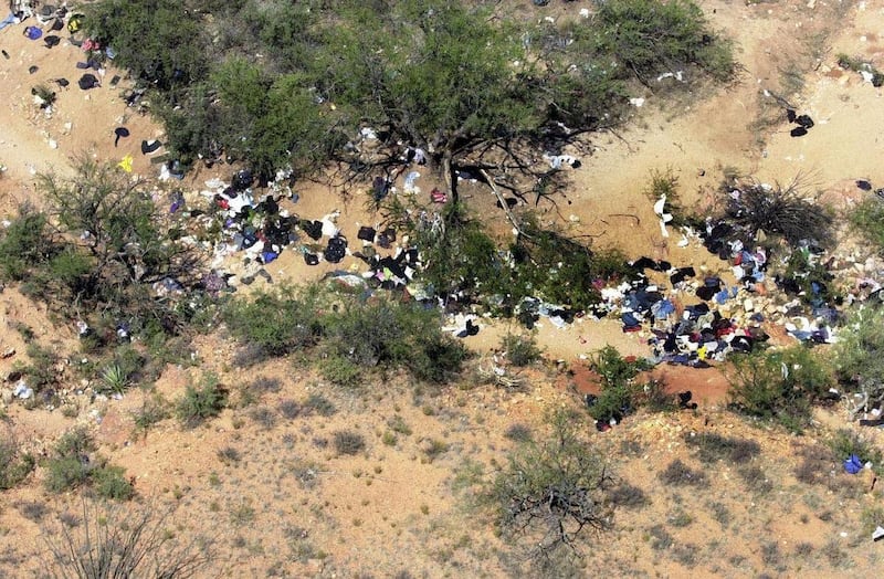FILE - Trash and clothing left by illegal aliens attempting to enter the United States for Mexico litter the desert floor as seen in an aerial view from a U.S. Immigration and Customs Enforcement Office Black Hawk helicopter near Arivaca, Ariz., south of