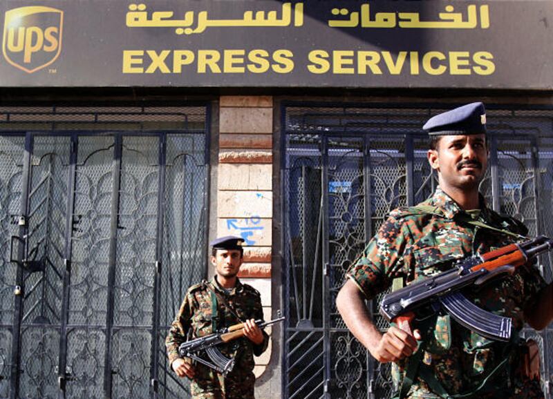 Armed Yemeni police stand guard by closed UPS office Thursday, Nov. 4, 2010, in San'a, Yemen. One of two mail bombs sent from Yemen last week was disarmed just 17 minutes before it was set to go off, the French interior minister said Thursday.