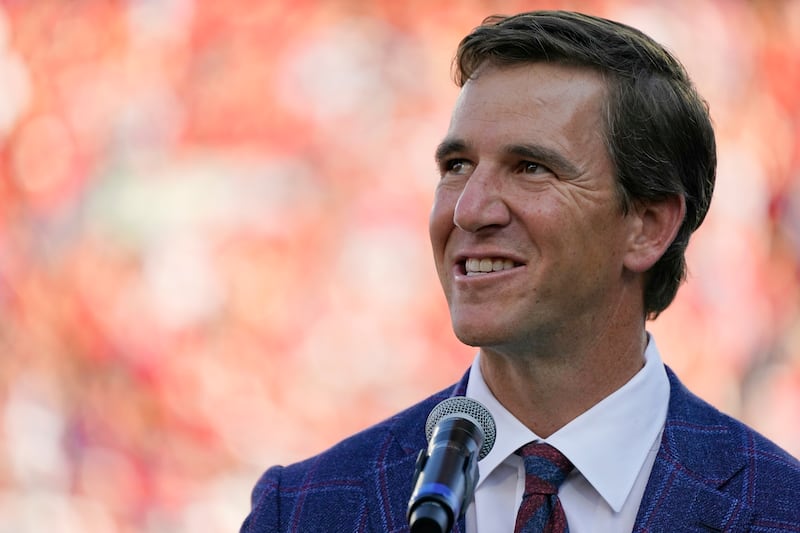 Former Mississippi quarterback Eli Manning addresses the crowd as his No. 10 jersey number is retired as part of the halftime jersey retirement ceremony.