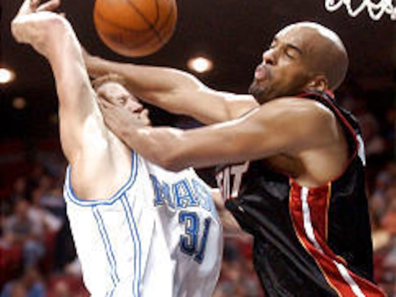 Former Ute Britton Johnsen (31) is fouled by Miami's Loren Woods.
