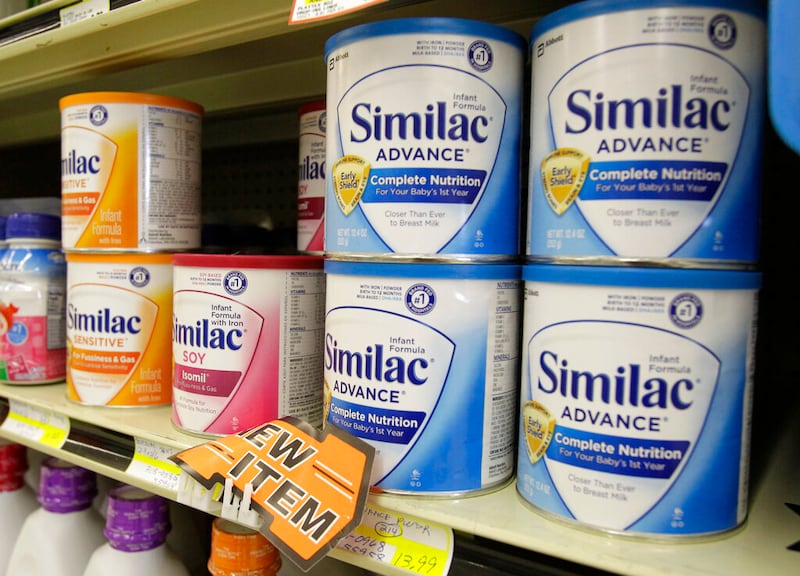Similac baby formula is displayed on the shelves.