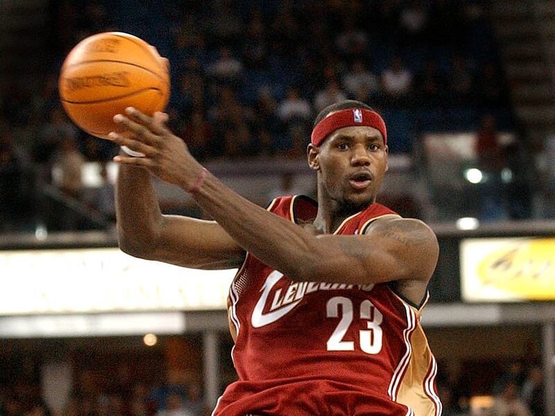 In this Oct. 29, 2003 file photo, Cleveland Cavaliers rookie guard LeBron James, passes as he drives the lane during his first regular season NBA basketball game, against the Sacramento Kings, at Arco Arena in Sacramento, Calif.