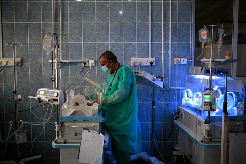 In this Saturday, June 27, 2020 file photo, a doctor checks a newborn baby inside an incubator at Al-Sabeen hospital in Sanaa, Yemen.