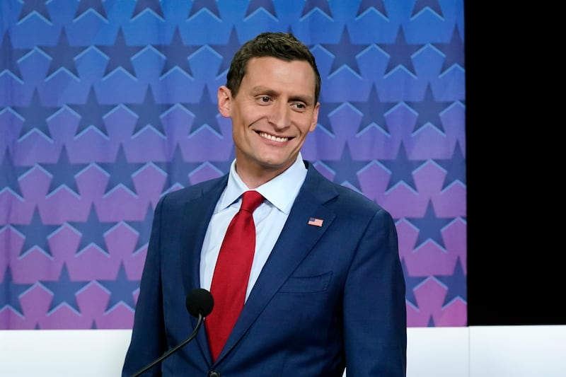 Republican Senate challenger Blake Masters smiles on stage prior to a televised debate in Phoenix.