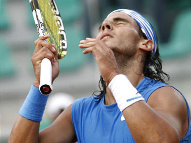 Spain's Rafael Nadal reacts after losing a point to compatriot Juan Carlos Ferrero during their men's second round match at the Rome Masters tennis tournament.