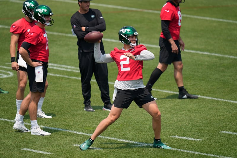 New York Jets quarterback Zach Wilson (2), second from right, throws at the team’s training facility in Florham Park, N.J.