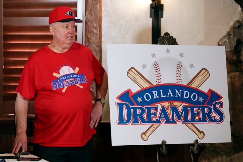 Pat Williams, co-founder of the NBA Orlando Magic basketball team, wears a T-shirt and hat with the logo “Orlando Dreamers” while announcing a campaign to bring a Major League Baseball team to Orlando.