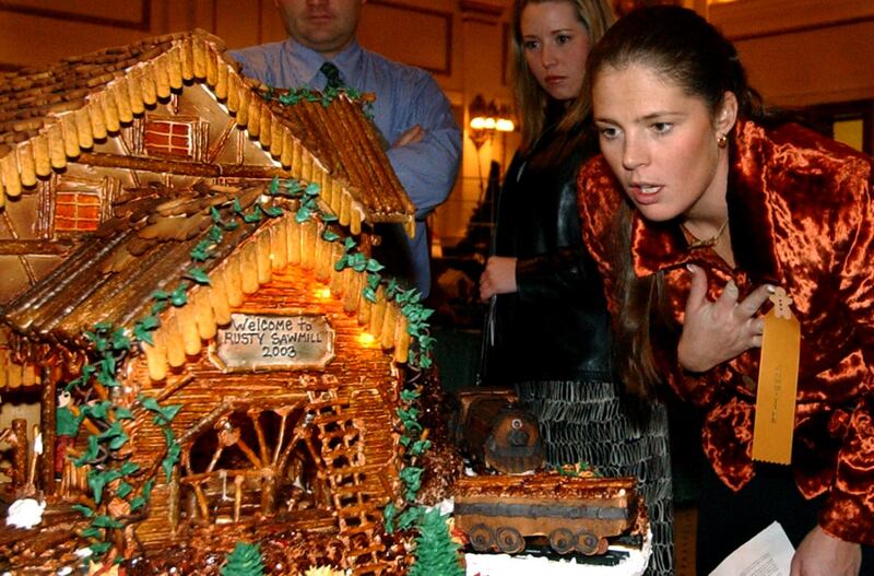 Picabo Street studies a gingerbread house.