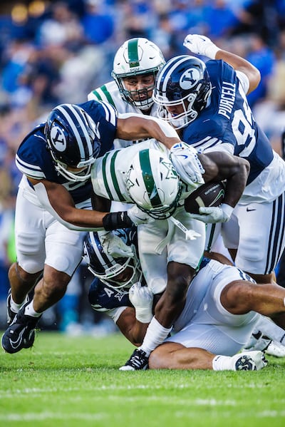 BYU defensive tackle Anisi Purcell, right, makes a tackle against Portland State in the Cougars' season opener on Aug. 30, 2025.