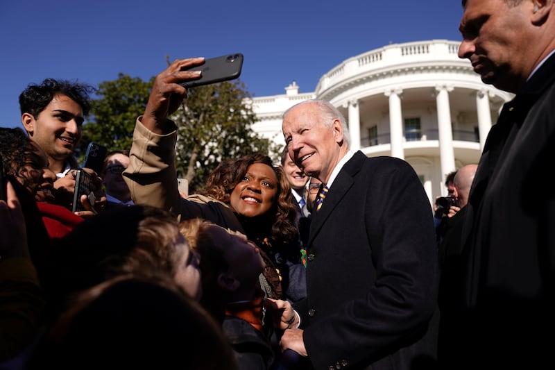 President Joe Biden takes a photo with attendees after a pardoning ceremony for the national Thanksgiving turkey.