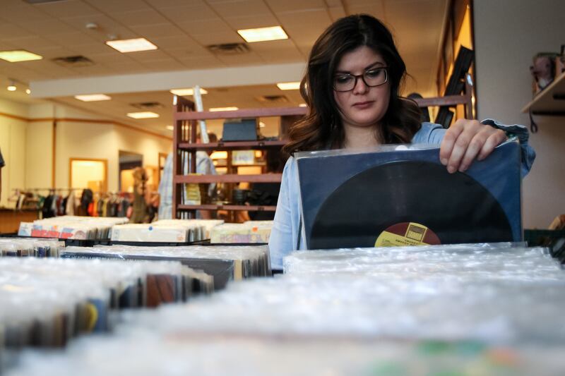 Kathleen Colon looks through records at the Urban Flea Market at The Gateway in Salt Lake City on Sunday, Nov. 12, 2017.