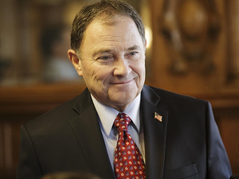 FILE — Governor Gary R Herbert smiles as he watches students from Franklin Elementary School, decorate a Christmas tree at the Governors mansion in Salt Lake City Tuesday, Dec. 1, 2015. Gov. Gary Herbert’s position is opposed by 31 other governors and eve