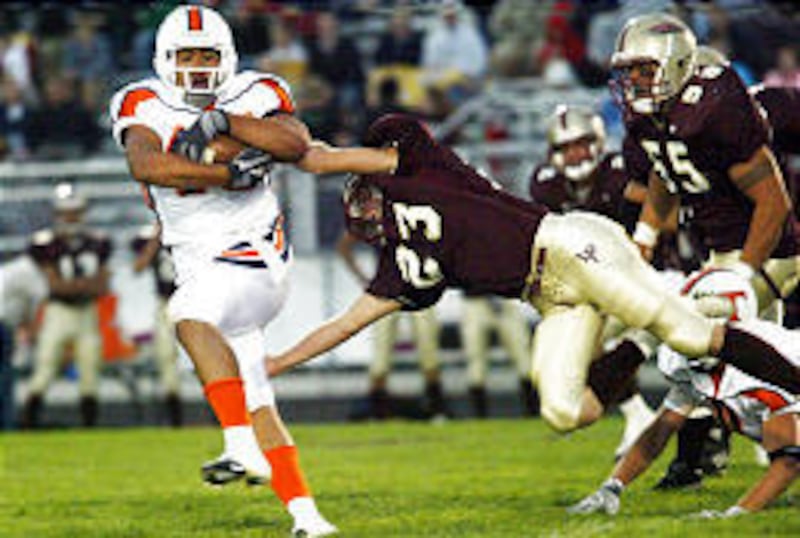 Timpview running back Harvey Unga, at far left, has been one of several weapons in the potent T-Bird attack this year. He is seen here breaking away from Lone Peak Russell Williams in a regular-season match-up.